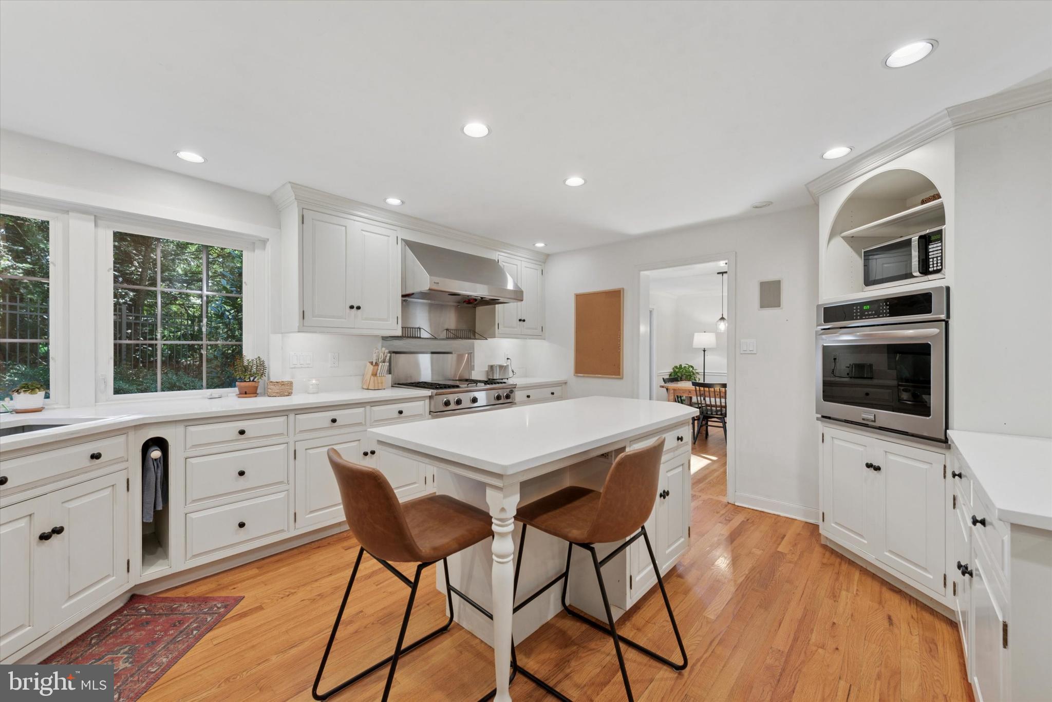 103 Deepdale Road Wayne, PA 19087 - Photo 8 of 41 a kitchen with stainless steel appliances kitchen island granite countertop a stove a sink a refrigerator and white cabinets with wooden floor
