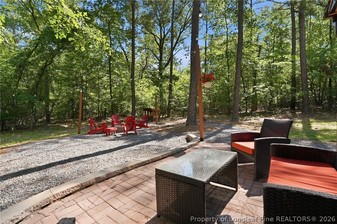 16 Ridge Road Jackson Springs, NC 27281 - Photo 44 of 50 a view of a patio with table and chairs and couches