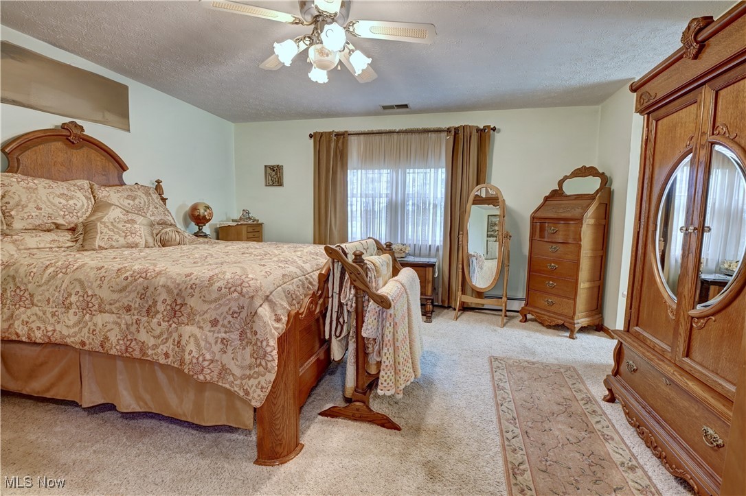 14965 Seacrist Road Salem, OH 44460 - Photo 13 of 43 Bedroom with a textured ceiling, light carpet, and ceiling fan