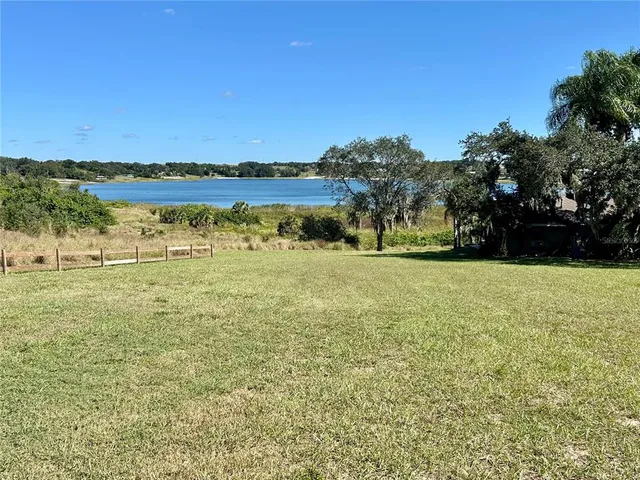 a view of a lake with houses in the background