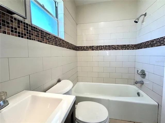 a white bath tub sitting next to a white toilet