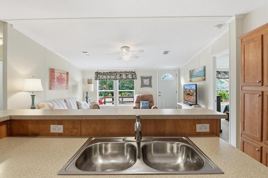 7305 South Threshold Point Homosassa, FL 34446 - Photo 12 of 46 a kitchen with a sink and a refrigerator