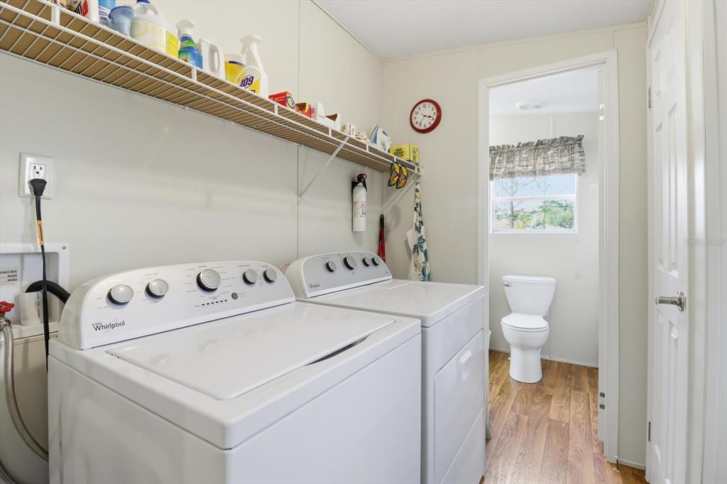 7305 South Threshold Point Homosassa, FL 34446 - Photo 13 of 46 a view of washer and dryer with bathroom in the background