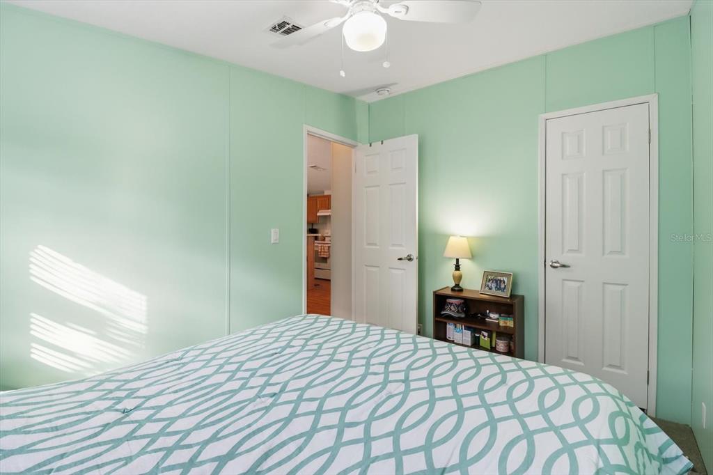 7305 South Threshold Point Homosassa, FL 34446 - Photo 16 of 46 a bedroom with a bed and a chandelier