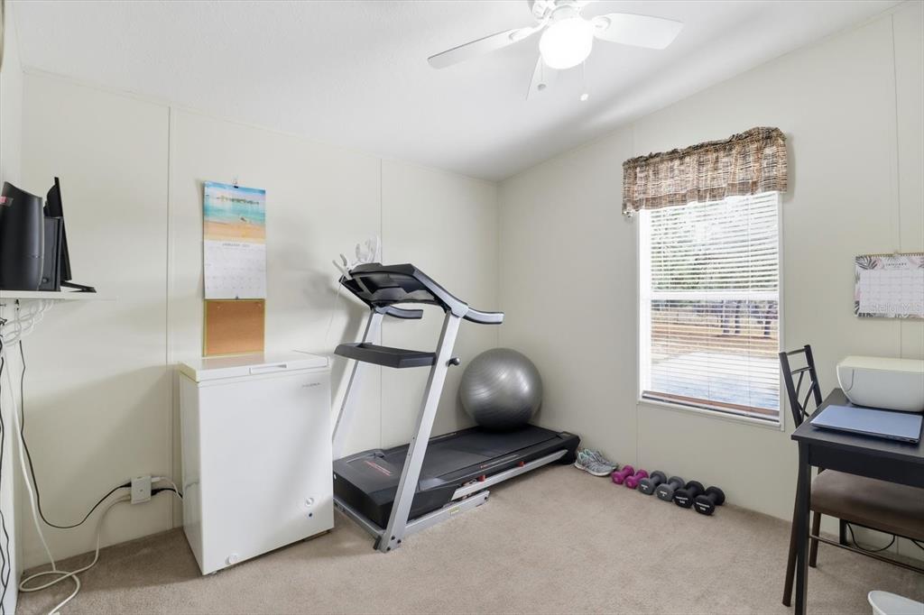 7305 South Threshold Point Homosassa, FL 34446 - Photo 19 of 46 a room with gym equipment and windows
