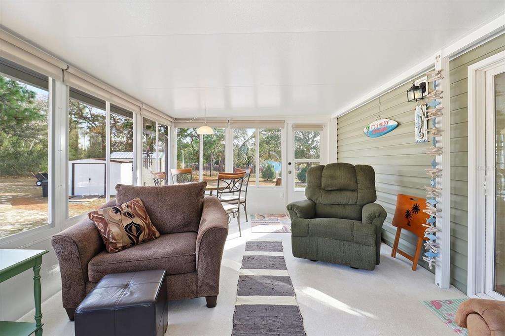 7305 South Threshold Point Homosassa, FL 34446 - Photo 25 of 46 a living room with furniture and a large window