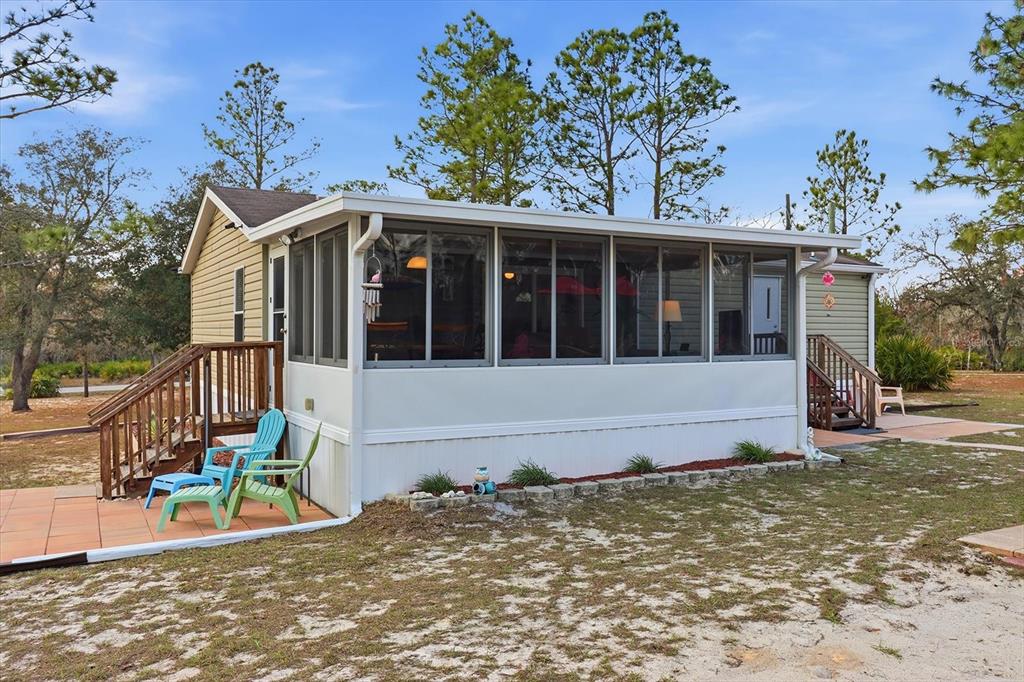 7305 South Threshold Point Homosassa, FL 34446 - Photo 28 of 46 a view of a house with a large tree and wooden fence