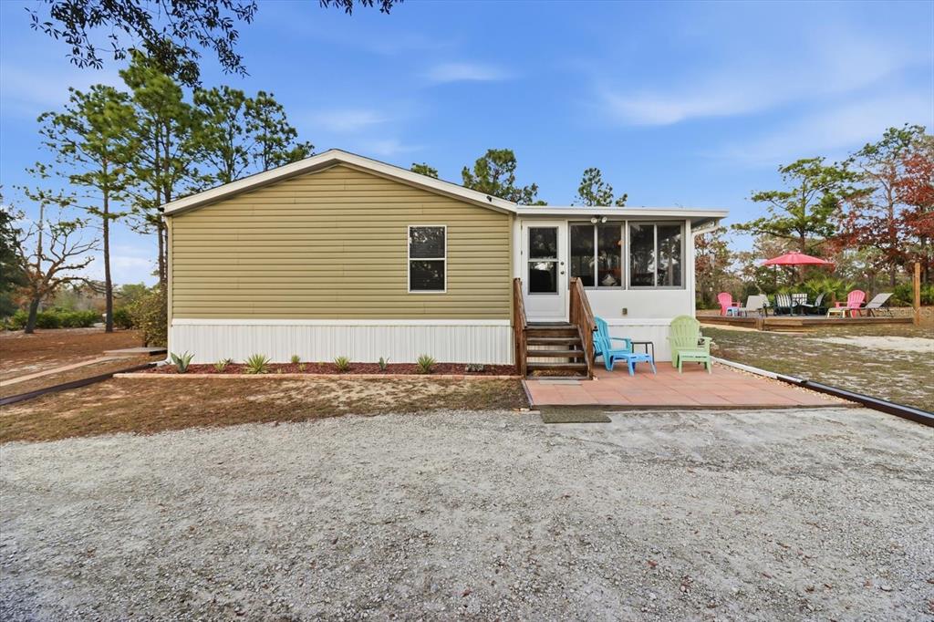 7305 South Threshold Point Homosassa, FL 34446 - Photo 29 of 46 a front view of a house with a yard and garage