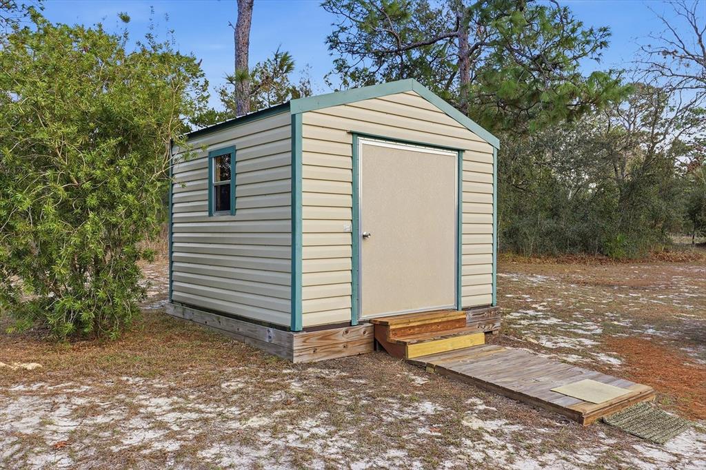 7305 South Threshold Point Homosassa, FL 34446 - Photo 35 of 46 a front view of a house with a yard