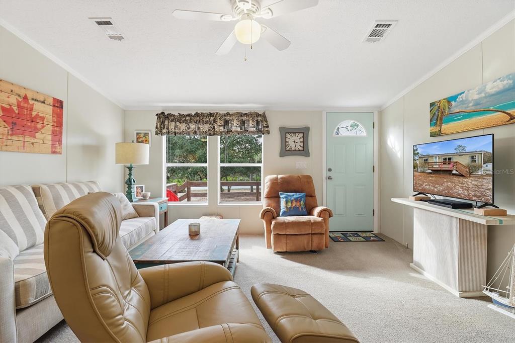 7305 South Threshold Point Homosassa, FL 34446 - Photo 7 of 46 a living room with furniture and a flat screen tv