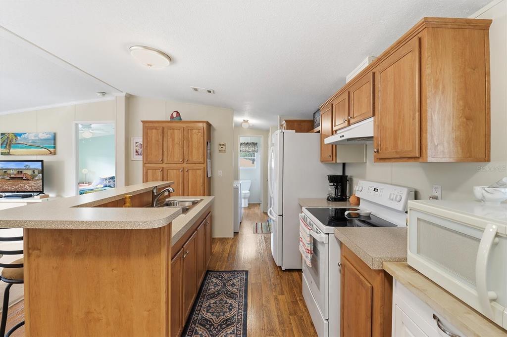 7305 South Threshold Point Homosassa, FL 34446 - Photo 10 of 46 a kitchen with a sink stove and refrigerator