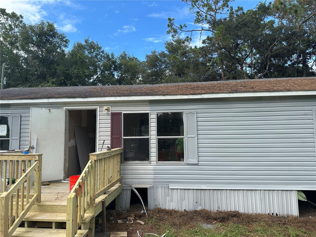 12955 Southeast 4th Place Silver Springs, FL 34488 - Photo 2 of 2 a view of house with deck and outdoor space
