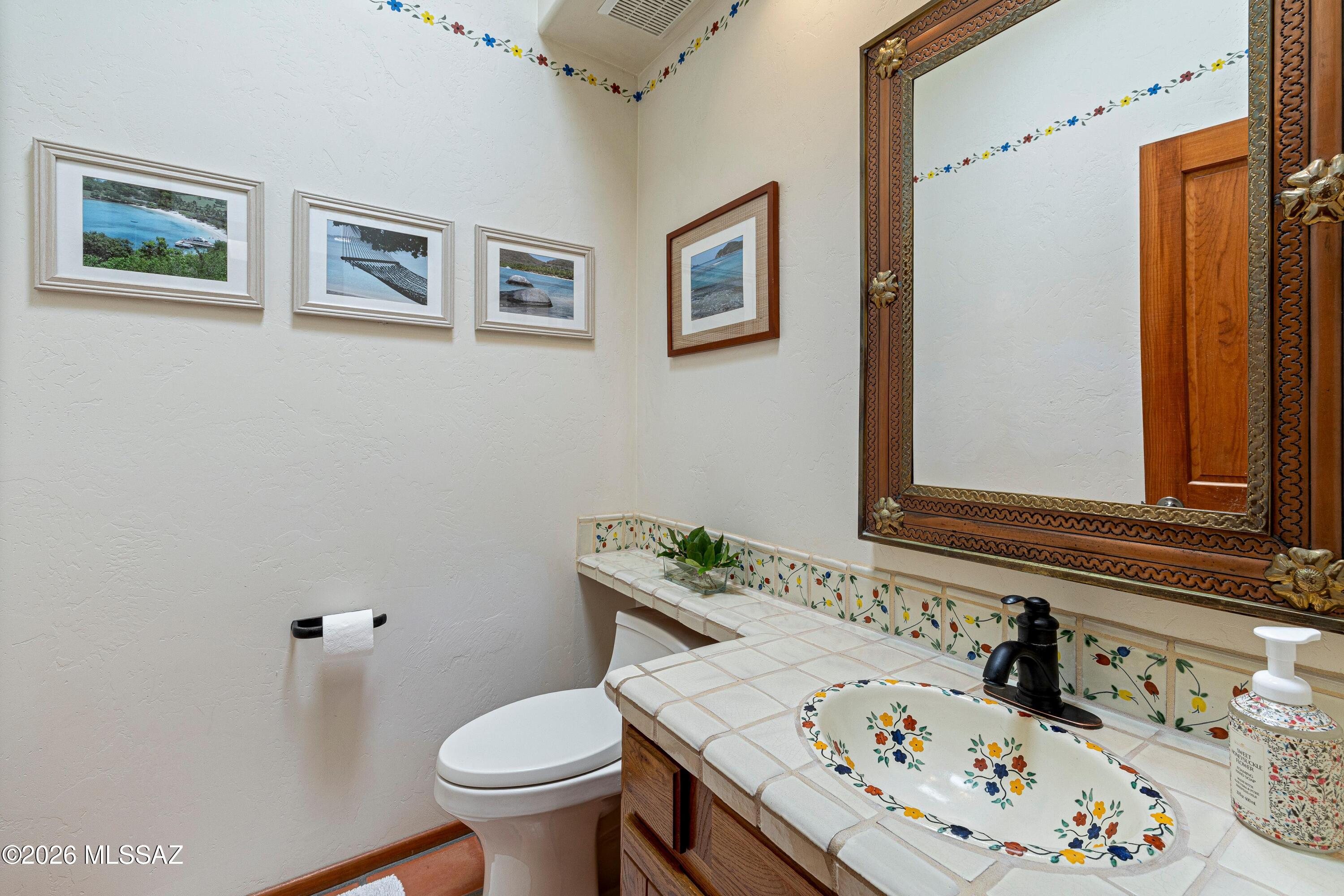11160 East Golf Links Road Tucson, AZ 85730 - Photo 24 of 51 Powder bathroom complete with hand painted Mexican tiles.