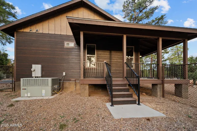 a front view of a house with a yard covered with snow