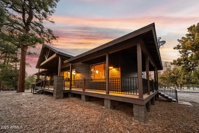 an aerial view of house with yard and mountain view in back