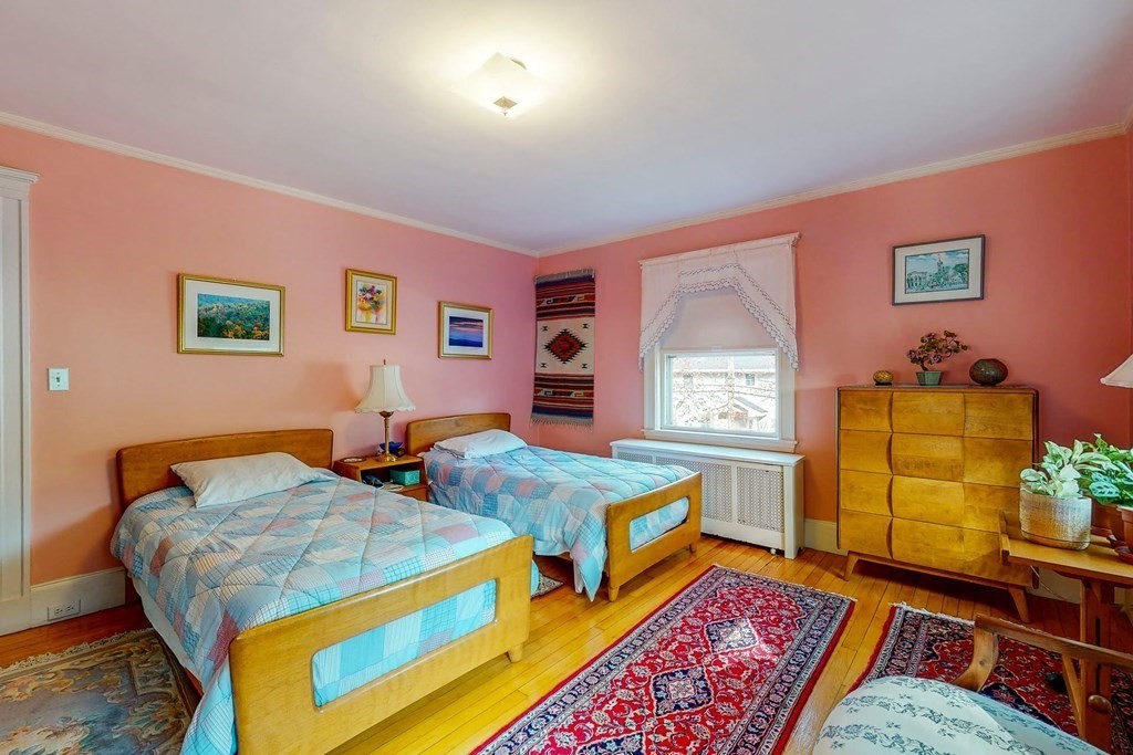 246 Clark Road Brookline, MA 02445 - Photo 11 of 18 a bedroom with two beds and paintings on the wall