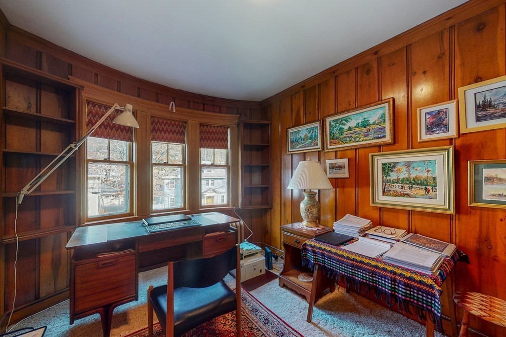 246 Clark Road Brookline, MA 02445 - Photo 13 of 18 a living room with furniture a bookshelf and a window