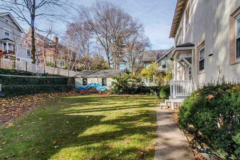 246 Clark Road Brookline, MA 02445 - Photo 18 of 18 a front view of a building with a garden