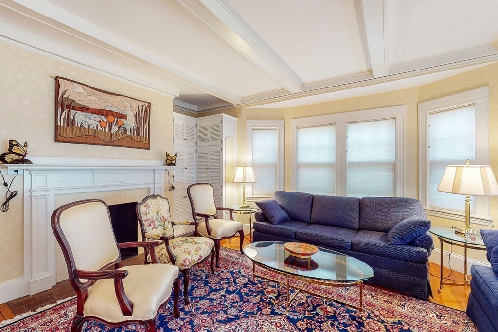 246 Clark Road Brookline, MA 02445 - Photo 3 of 18 a living room with furniture and a fireplace