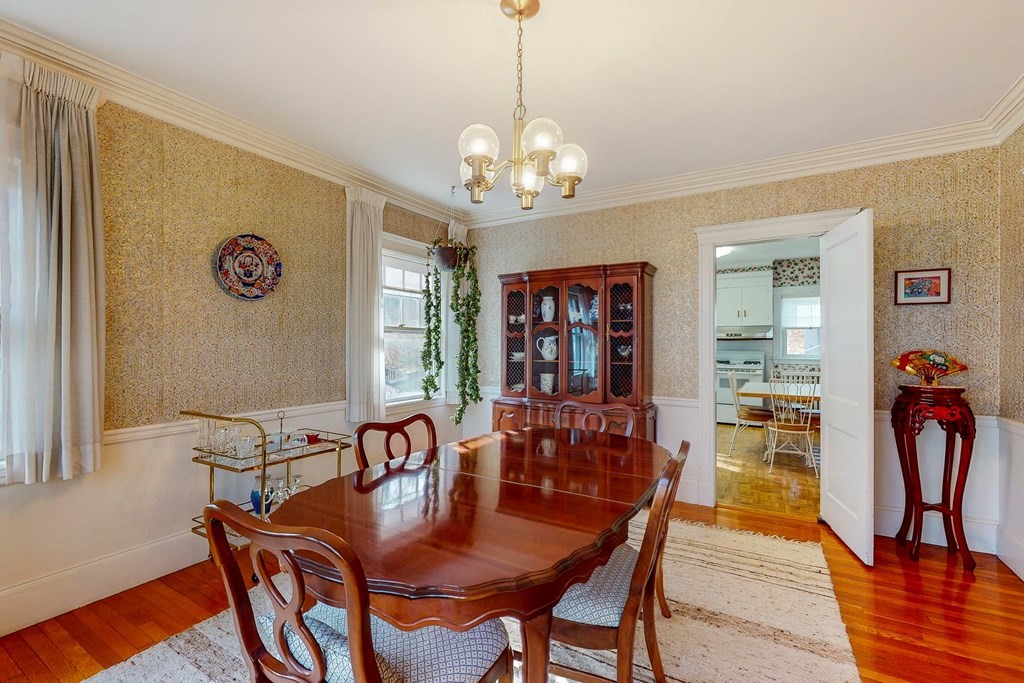 246 Clark Road Brookline, MA 02445 - Photo 6 of 18 a view of a dining room with furniture wooden floor and a chandelier