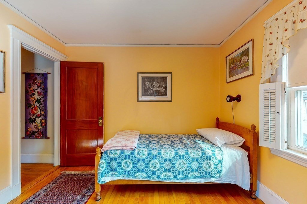 246 Clark Road Brookline, MA 02445 - Photo 9 of 18 a bedroom with a bed and a painting on the wall