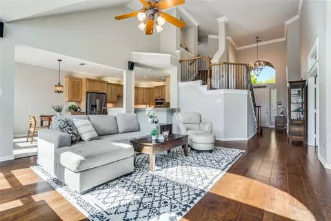 a living room with furniture and a chandelier