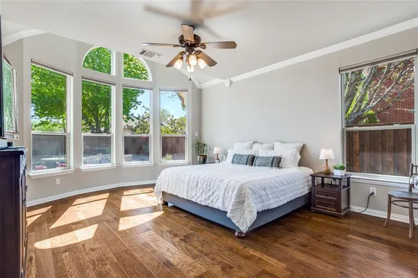 a bedroom with a bed and a large window