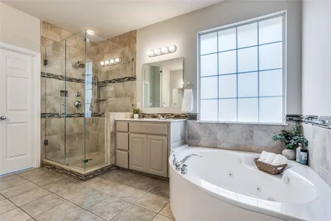 a bathroom with a tub a sink and a shower
