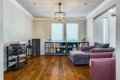 a living room with furniture a window and bookshelf