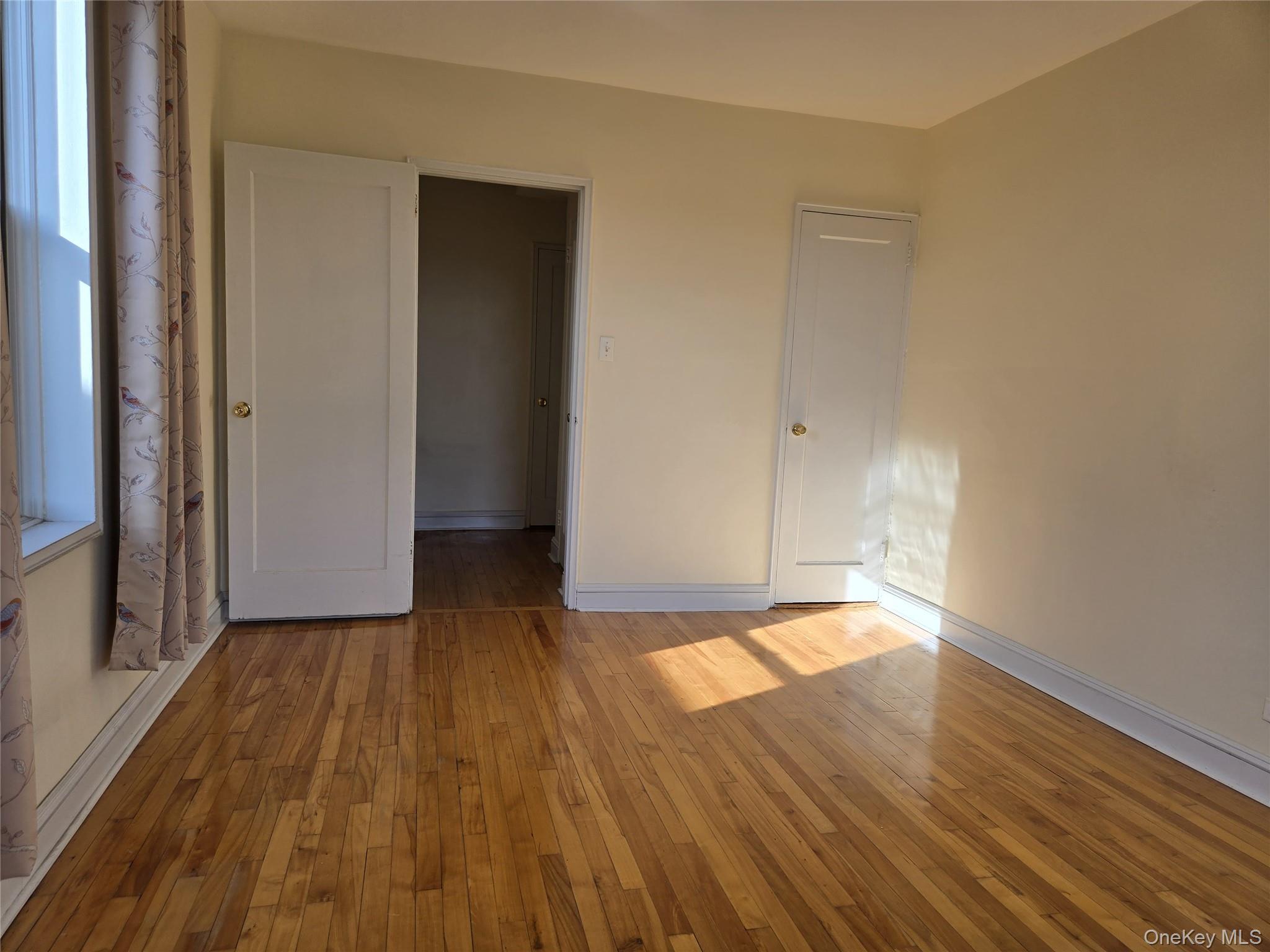 87-09 34th Avenue, Unit 6K Queens, NY 11372 - Photo 12 of 12 a view of empty room with wooden floor