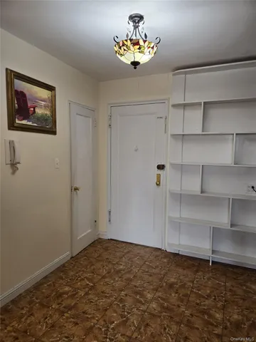 a view of empty room with wooden floor and windows