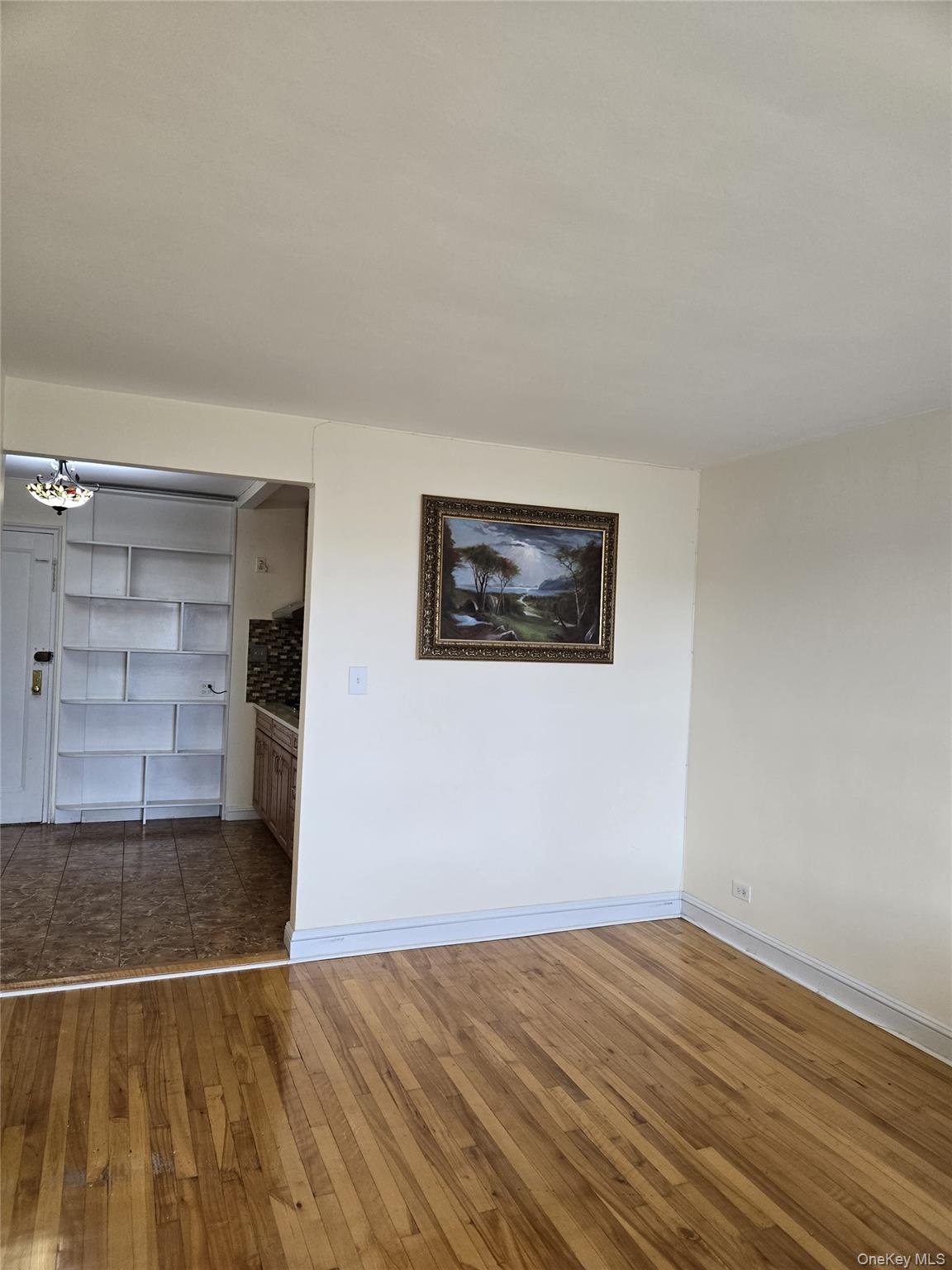 87-09 34th Avenue, Unit 6K Queens, NY 11372 - Photo 7 of 12 a view of empty room with wooden floor and windows