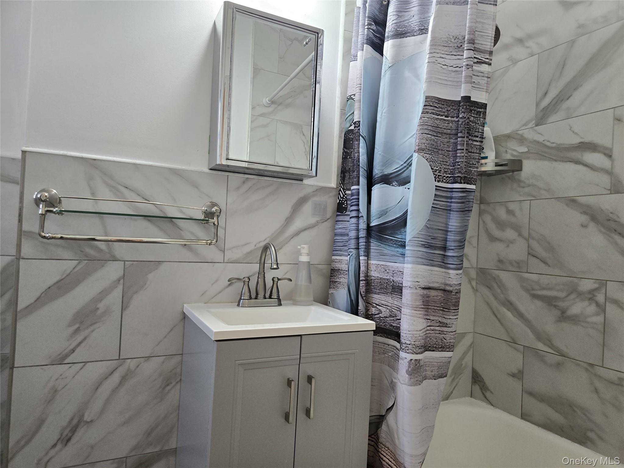 87-09 34th Avenue, Unit 6K Queens, NY 11372 - Photo 9 of 12 a bathroom with a sink toilet and shower