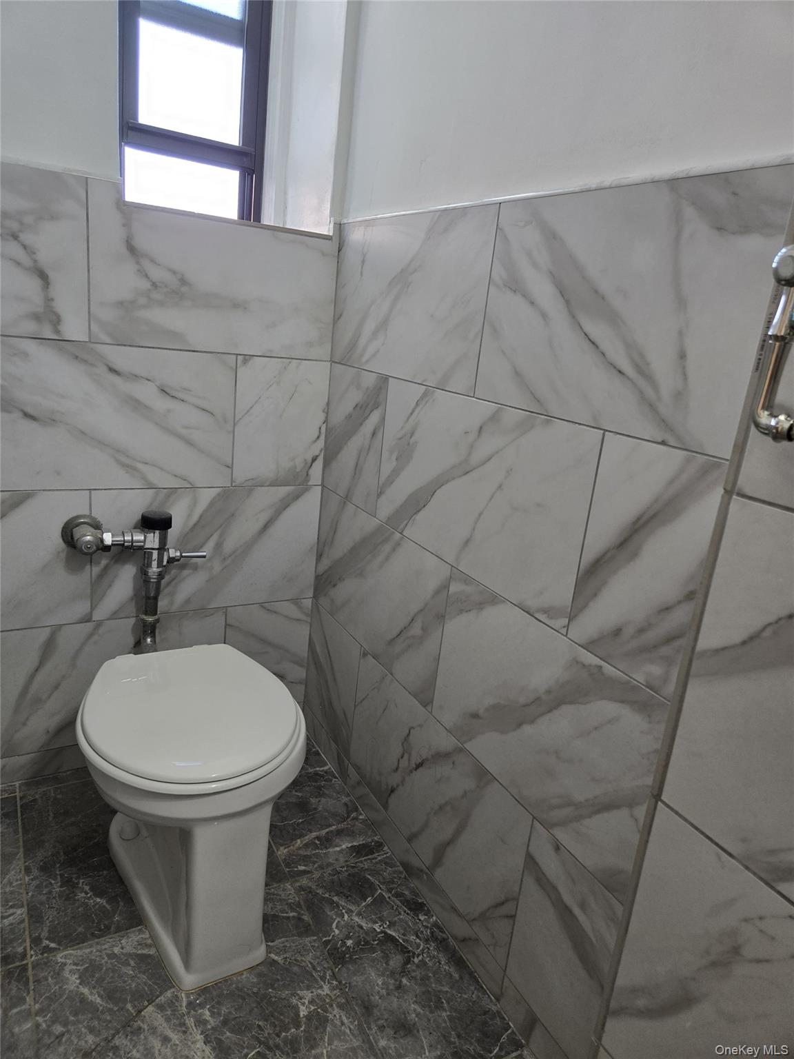 87-09 34th Avenue, Unit 6K Queens, NY 11372 - Photo 10 of 12 a bathroom with a toilet and a sink