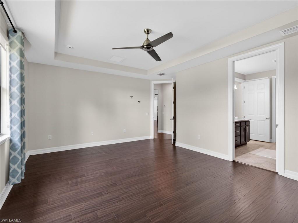 6124 Victory Drive Ave Maria, FL 34142 - Photo 27 of 50 a view of an empty room with wooden floor and a window