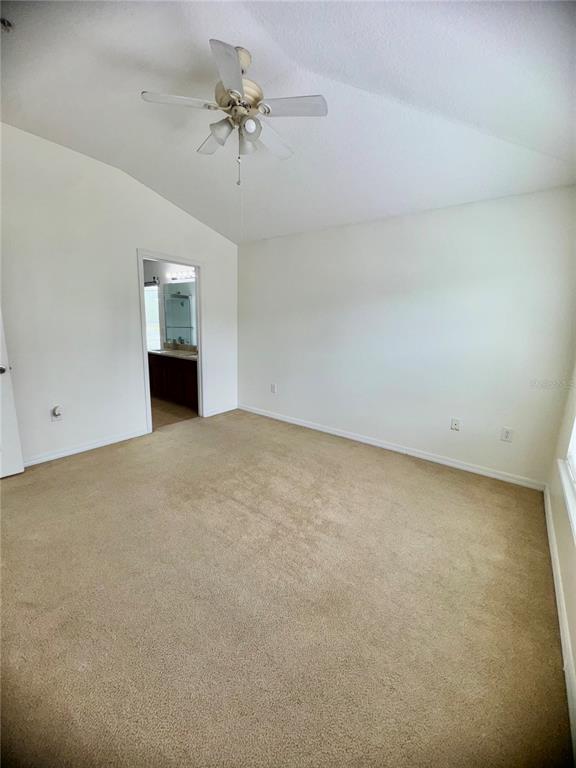 6404 South Goldenrod Road, Unit 2A Orlando, FL 32822 - Photo 32 of 40 en empty room with windows and ceiling fan