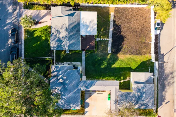 an aerial view of a house with a yard and fountain
