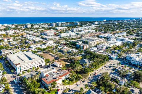 an aerial view of residential houses with outdoor space and street view
