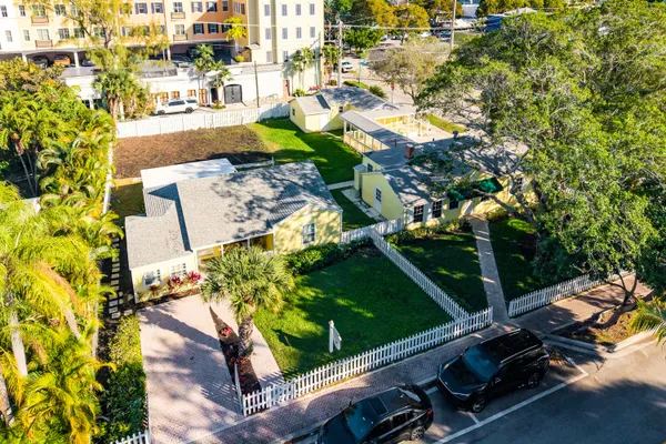 an aerial view of a residential houses with yard