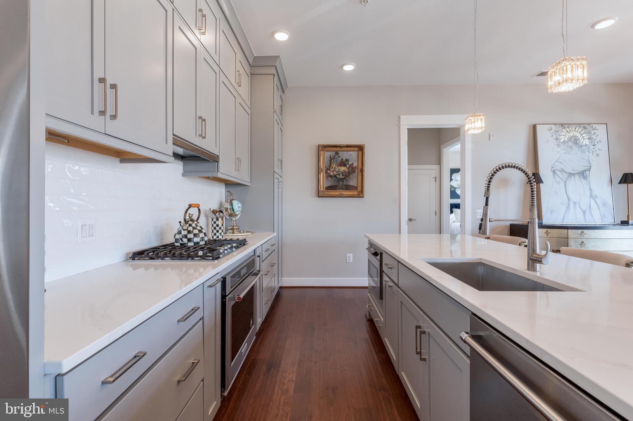 2 Stationmaster Street Southeast, Unit 202 Leesburg, VA 20175 - Photo 12 of 29 a kitchen with granite countertop a sink and cabinets