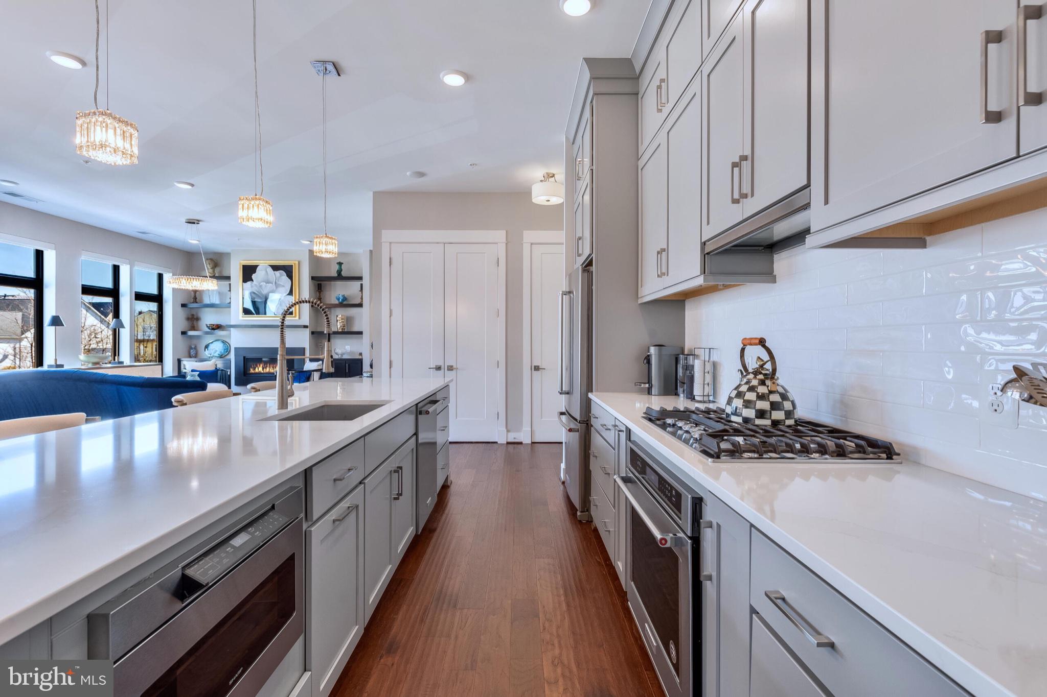 2 Stationmaster Street Southeast, Unit 202 Leesburg, VA 20175 - Photo 13 of 29 a kitchen with stainless steel appliances granite countertop a stove and a sink