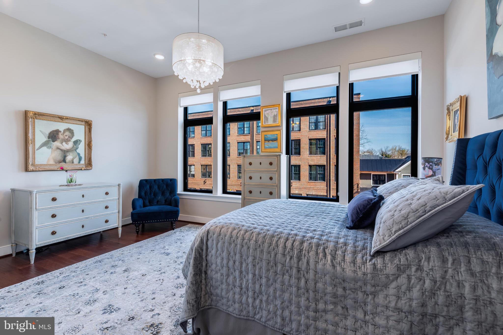 2 Stationmaster Street Southeast, Unit 202 Leesburg, VA 20175 - Photo 23 of 29 a bedroom with a bed dresser and a window