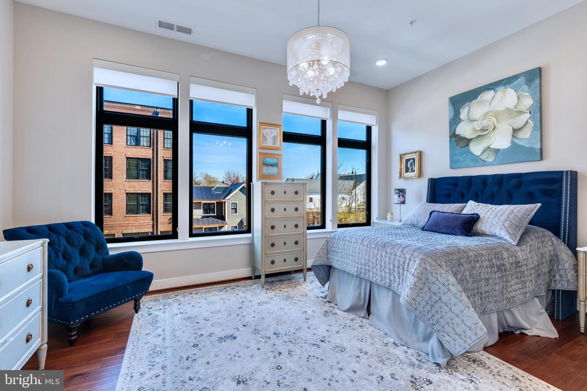 2 Stationmaster Street Southeast, Unit 202 Leesburg, VA 20175 - Photo 25 of 29 a spacious bedroom with a large bed and a couch