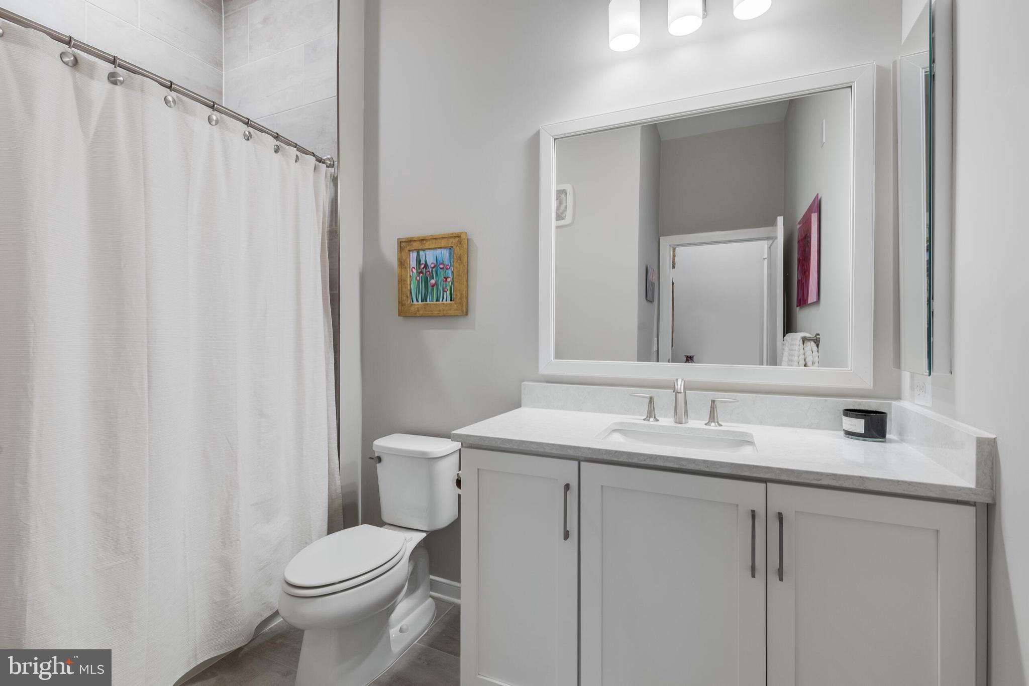 2 Stationmaster Street Southeast, Unit 202 Leesburg, VA 20175 - Photo 26 of 29 a bathroom with a sink a toilet and mirror