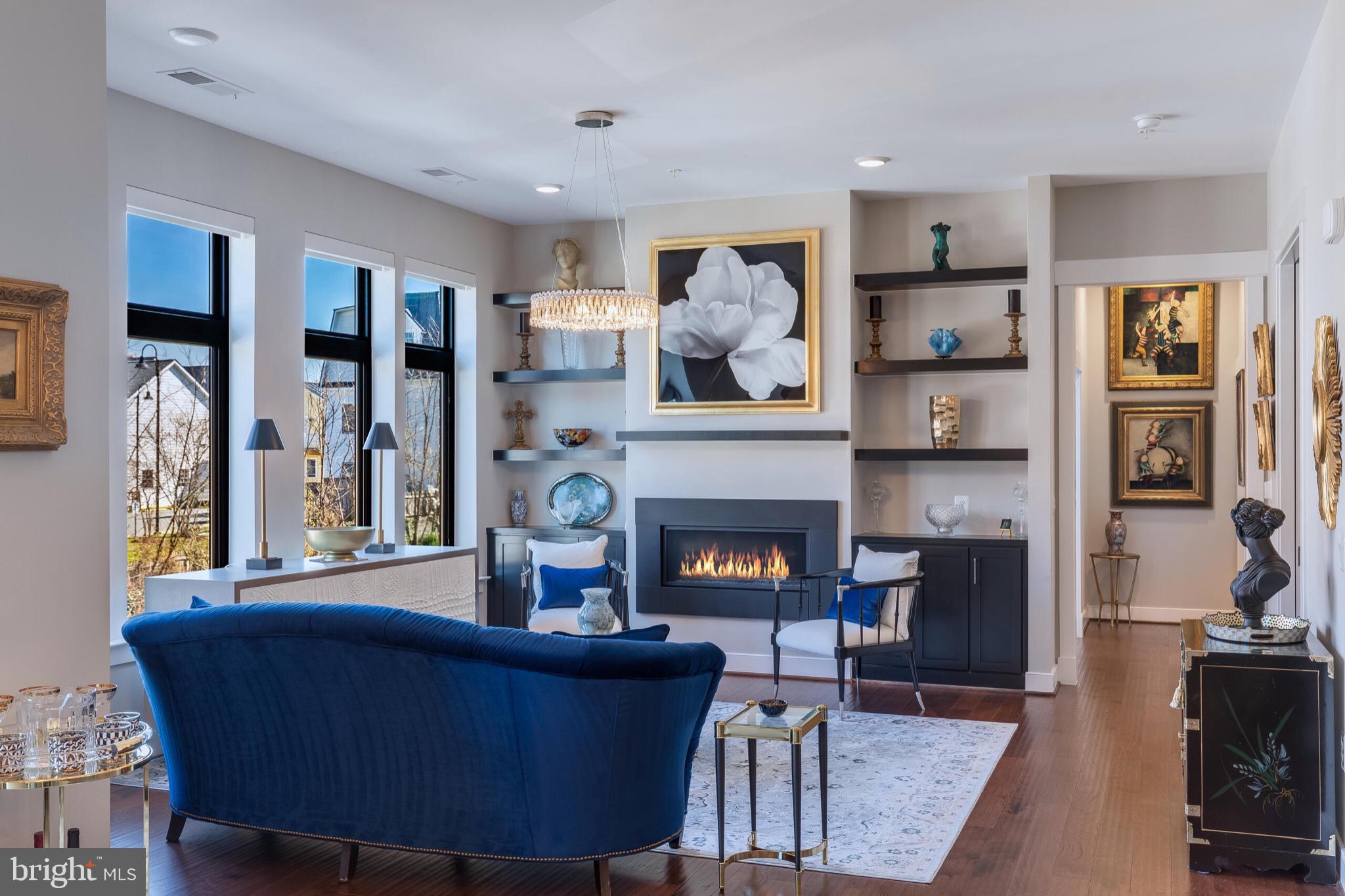 2 Stationmaster Street Southeast, Unit 202 Leesburg, VA 20175 - Photo 6 of 29 a living room with furniture and a fireplace