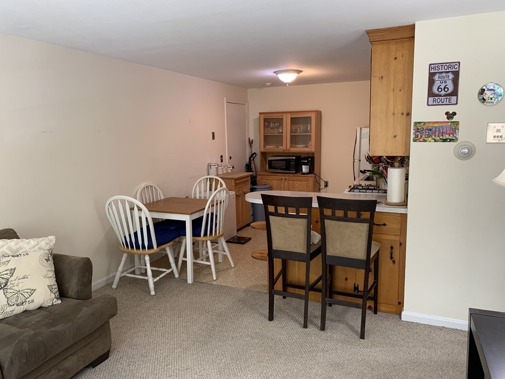 180 Tyngsboro Road, Unit 55D Chelmsford, MA 01863 - Photo 11 of 20 a view of a dining room with furniture