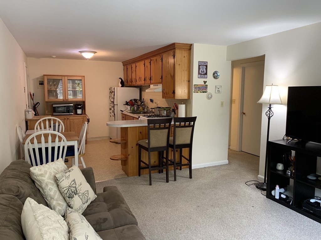 180 Tyngsboro Road, Unit 55D Chelmsford, MA 01863 - Photo 12 of 20 a view of a livingroom with furniture and a flat screen tv