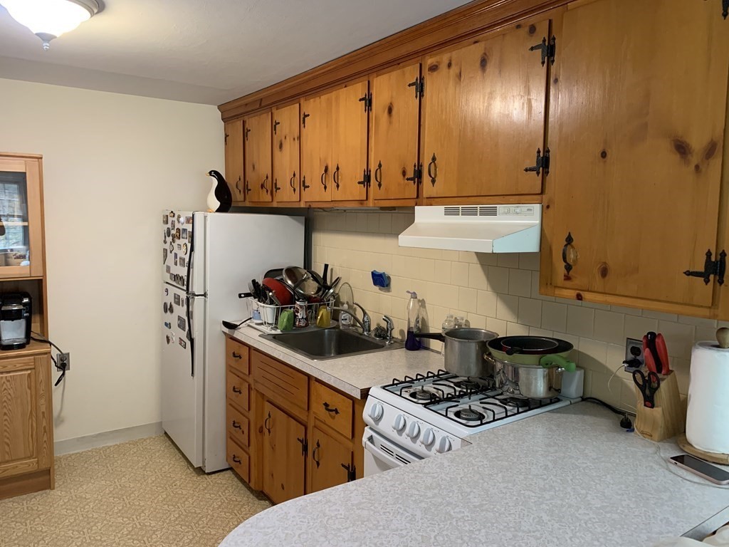 180 Tyngsboro Road, Unit 55D Chelmsford, MA 01863 - Photo 14 of 20 a kitchen with stainless steel appliances granite countertop a stove and a sink