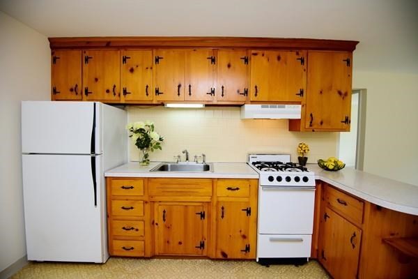 180 Tyngsboro Road, Unit 55D Chelmsford, MA 01863 - Photo 17 of 20 a kitchen with cabinets appliances and wooden floor