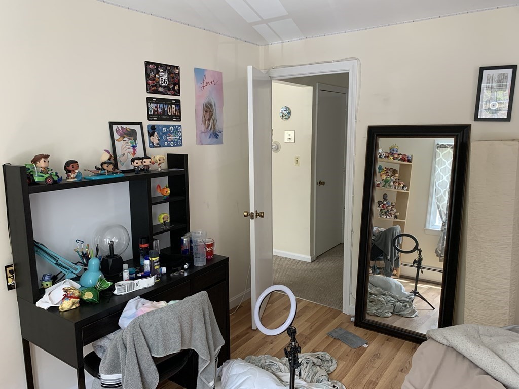 180 Tyngsboro Road, Unit 55D Chelmsford, MA 01863 - Photo 7 of 20 a living room with furniture and wooden floor